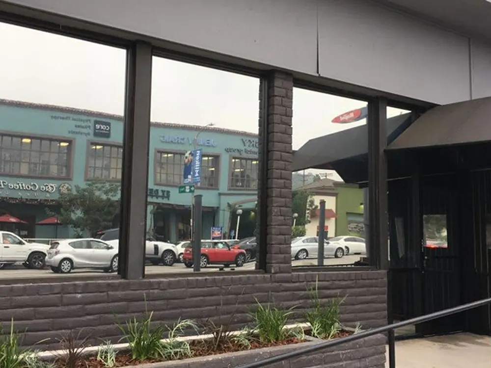 A neighbourhood storefront filmed to cut glare while keeping the display visible.