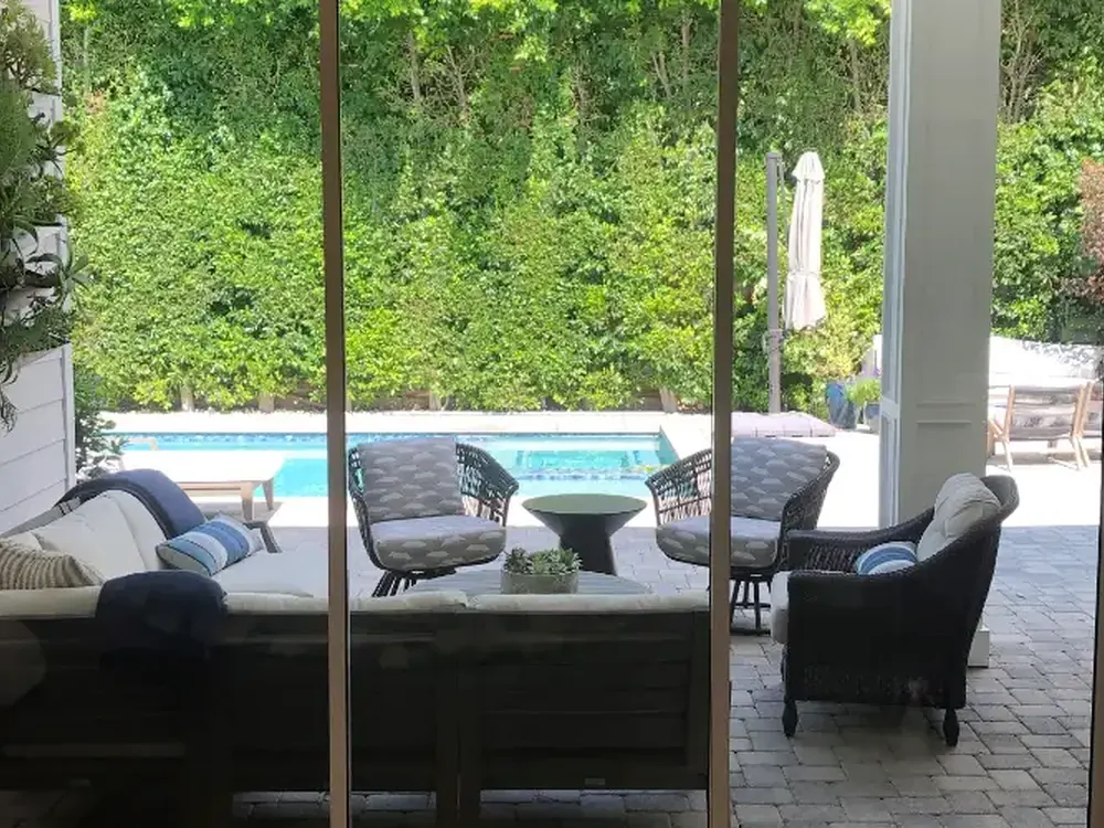 Full-height patio doors carrying clear film that holds the glass together on impact.