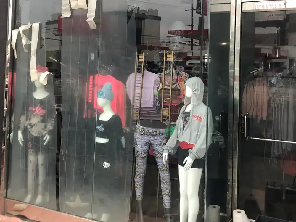 Scratched shopfront glazing obscuring the merchandise behind it.